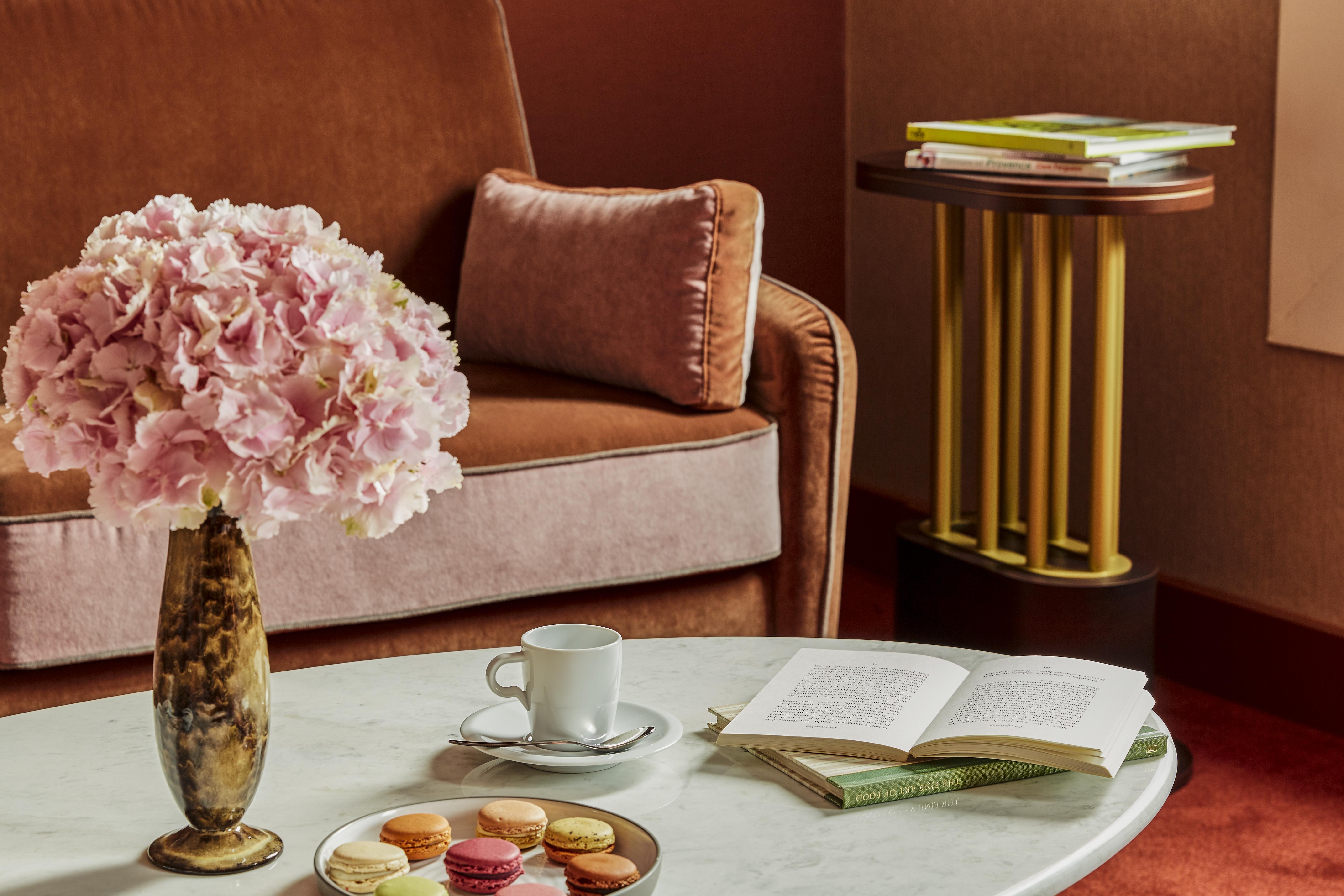 Nest Paris La Defense - Mgallery Puteaux Ngoại thất bức ảnh A table with a coffee cup and saucer, a book, and a vase of flowers